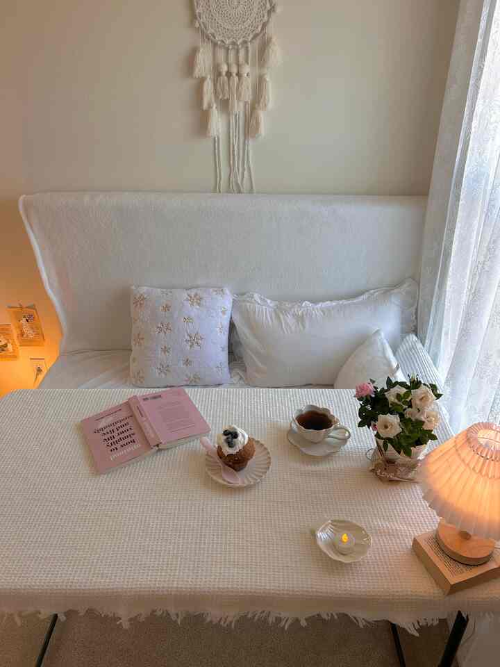 #myhousemycorners 
Our guest room is actually my little dessert nook.
It’s small, which makes it feel even cozier, and I decorated it all in white to give it a soft, comforting vibe.
With lace curtains and a large window to gaze out of, it’s the perfect spot to read a book and enjoy a sweet treat.
This nook has truly become one of my favorite places — a space I genuinely love.
🤍

#apartmentaesthetic #itsmyhouseandilivehere #interiordesign #apartmenttour #itsmyhouse