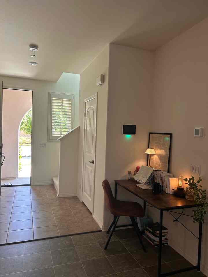 Cozy workspace corner with white walls and brown furniture featuring warm lighting for reading and writing