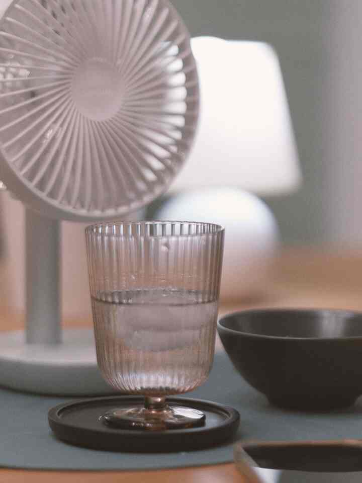 Minimal space featuring silicone placemats, coasters, and a glass on a softly toned table surface