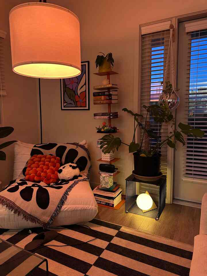 Light gray and black toned living room featuring cozy lighting and plants with a comfortable atmosphere