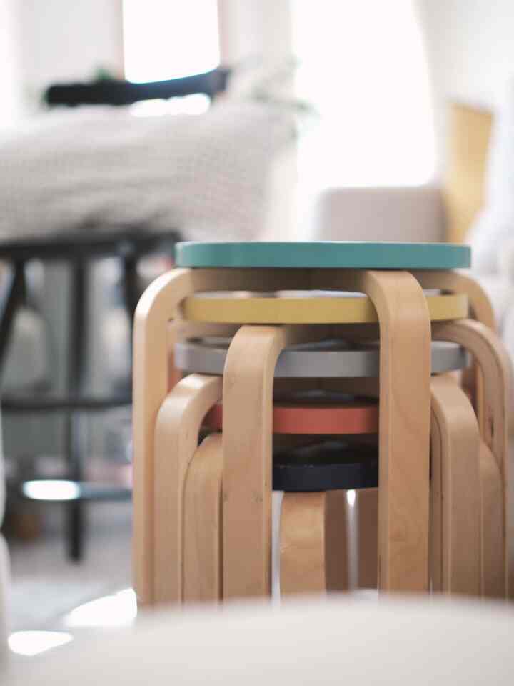Bright and cozy living room featuring stacked natural wood tone stools