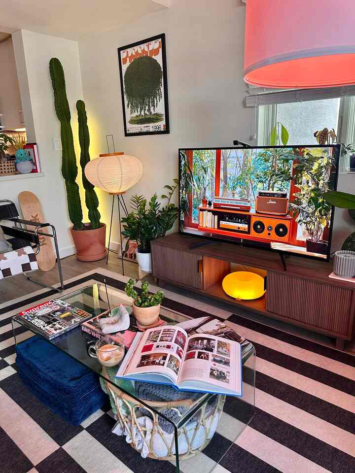 Natural and black toned living room featuring sofa, TV stand, and coffee table with cozy atmosphere