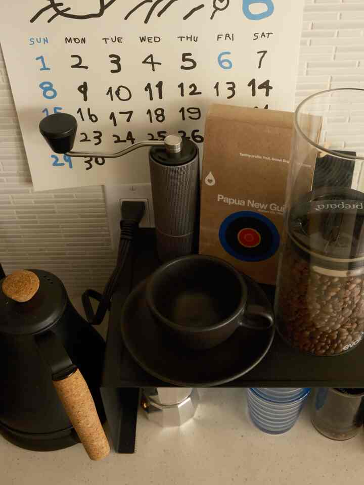 Compact home cafe space in black and brown tones, cozy coffee corner organized with coffee tools and beans