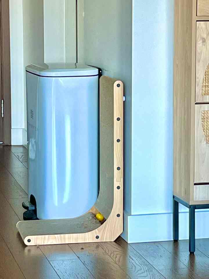 White and wood-toned entrance featuring a shoe cabinet and a cat scratching post in a pet-friendly setup