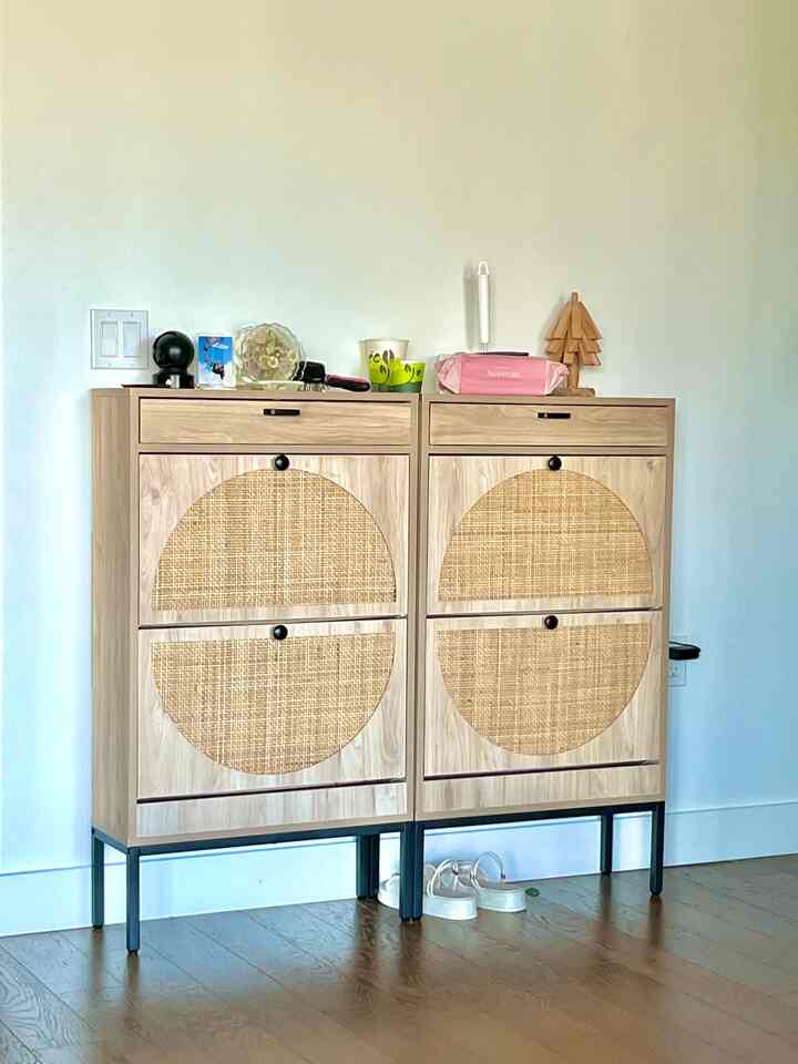 Natural wood tone shoe cabinet in a clean, cozy entrance space