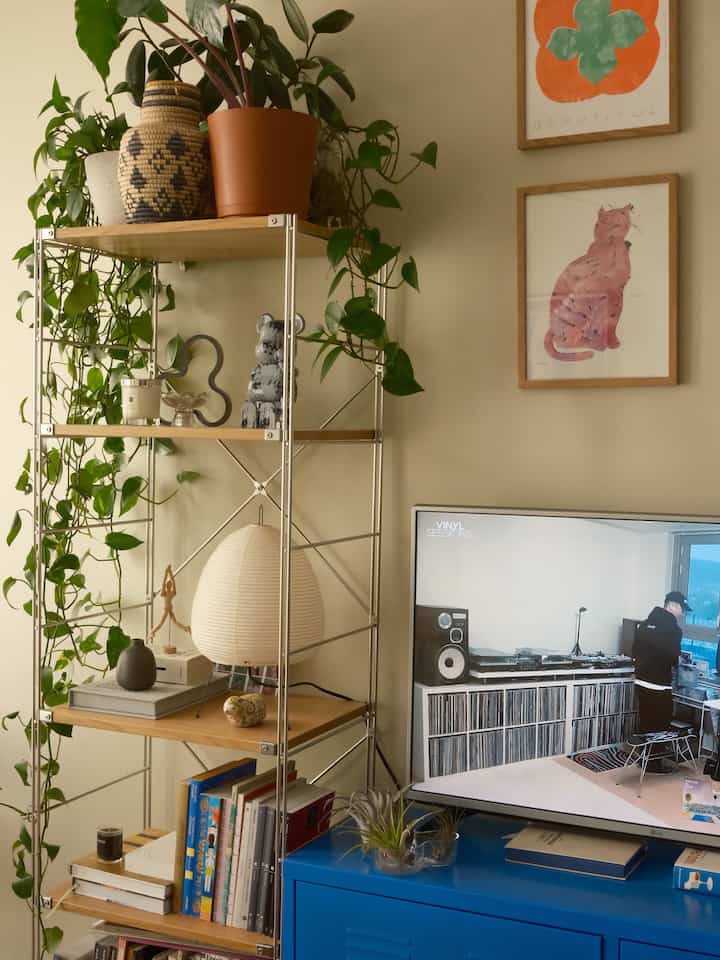 Natural tone living room featuring plants, Akari lamp, and wall art in a Nordic style interior
