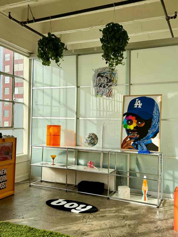White and orange toned home gallery space with modern metal shelving and art pieces, featuring an Instagrammable interior vibe