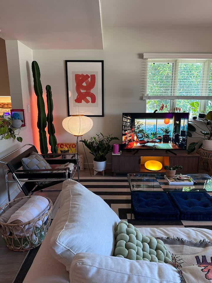 White and blue toned living room featuring sofa and TV with a natural and simple atmosphere