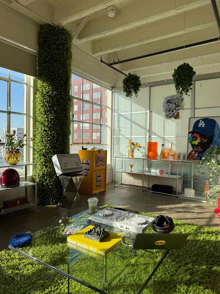 Modern living room with warm natural light, green rug, and plants creating an inviting atmosphere