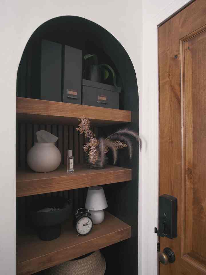 A neatly styled arched open cabinet creates a warm and welcoming vibe.

#entrywaydecor #entrancedecor #entrywaydesign #entrancehall #entranceinterior #Entranceshoecabinet #entrancehallwayinterior #opencloset #DIY #modern #Nordicinterior #fallinterior 
