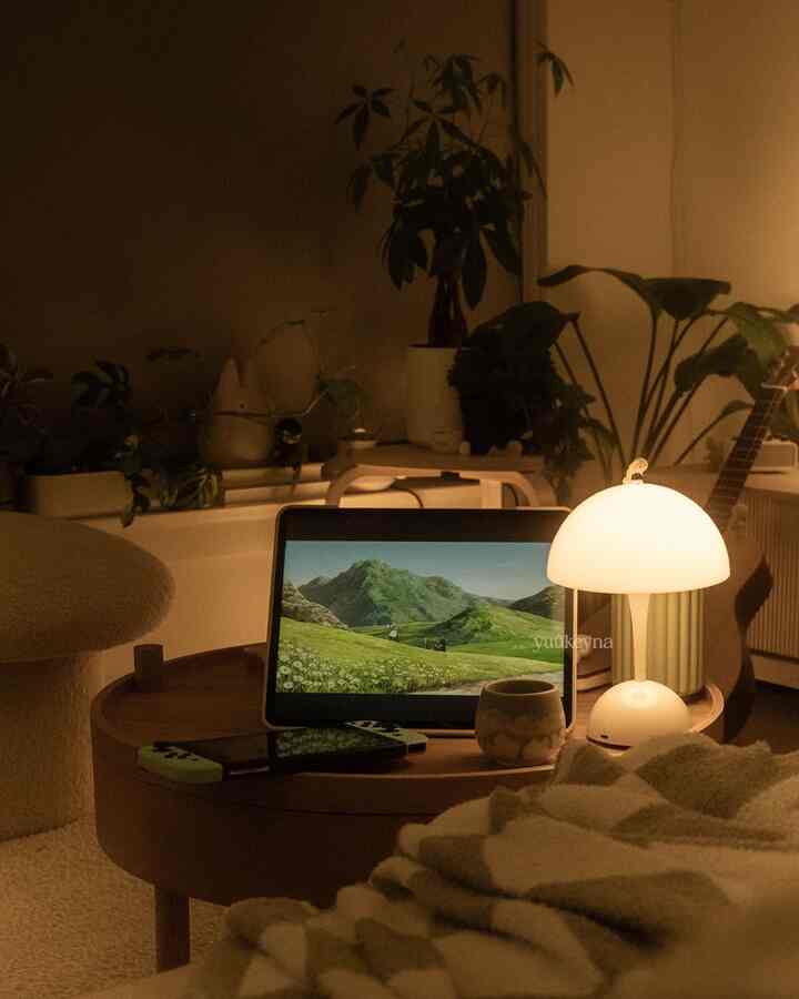 Warm beige and wood tone living room featuring a round wooden tray table and soft ambient lighting creating a cozy atmosphere