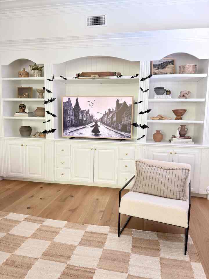 Adding some Halloween decor into our living room. Bats and tv art make a big ipact for cheap! #halloweendecor #halloweenideas #livingroomdecor