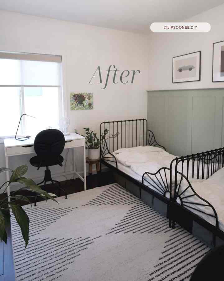 A modern two-person bedroom with white and black tones, featuring twin beds, a desk, and green plants creating a clean atmosphere