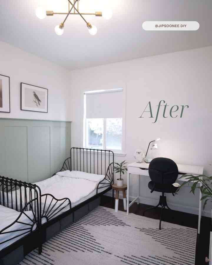 A small bedroom in white and black tones featuring two beds and a work desk with a clean, natural atmosphere