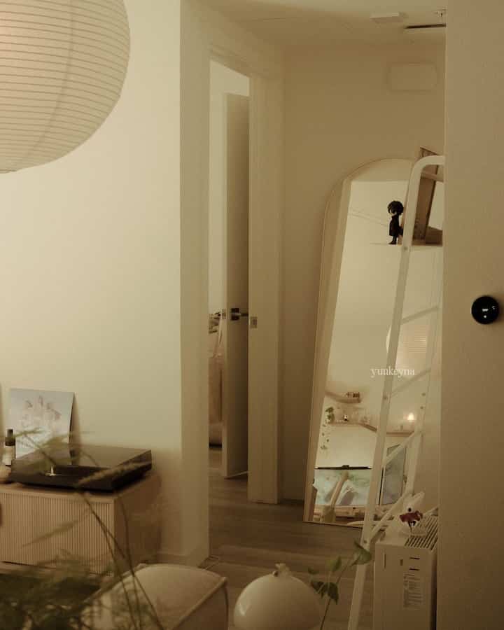 Natural color toned hallway featuring a Yamazaki shelf and full-length mirror with a minimalist, simple interior