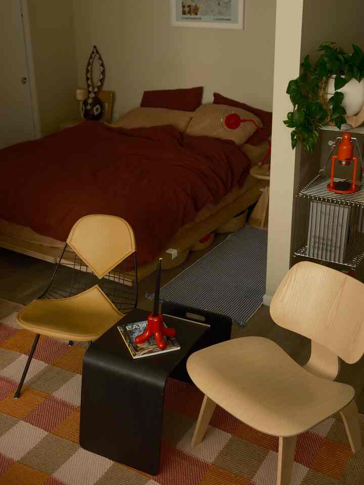 Warm brown and wood-tone bedroom featuring mid-century modern furniture with a cozy autumnal atmosphere