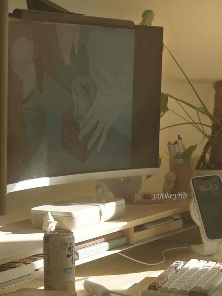 Warm wood tone Japandi style home office desk space bathed in golden hour sunlight with a cozy atmosphere