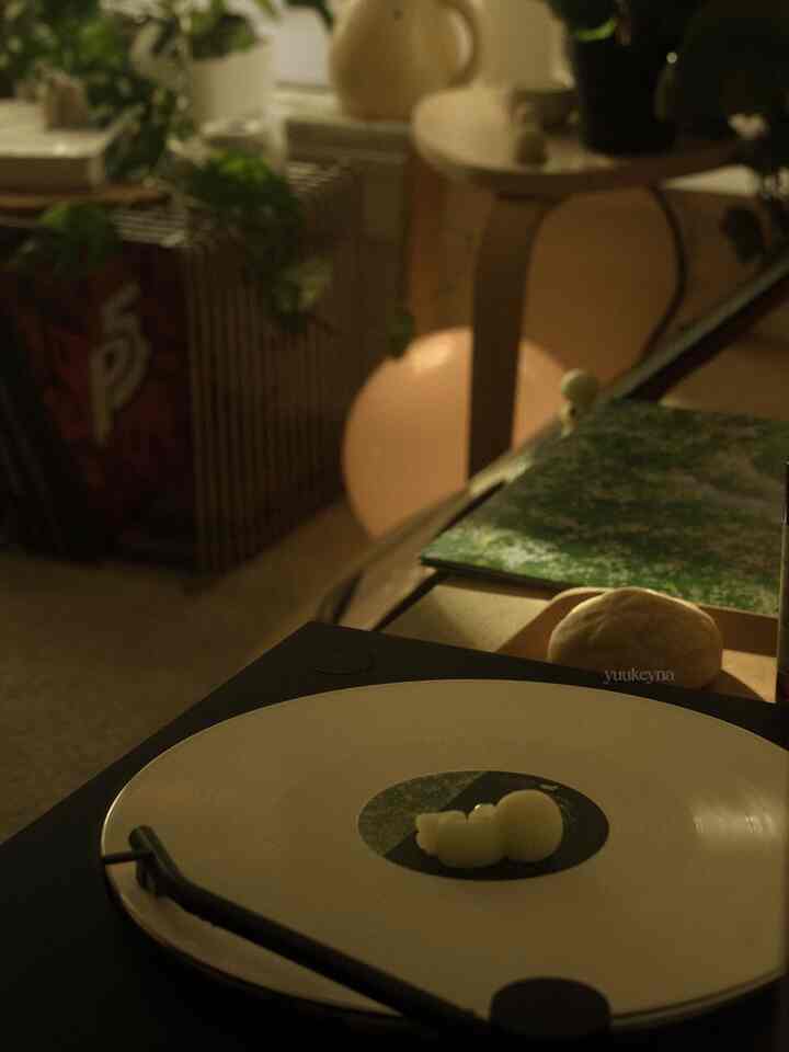 White and brown toned living room corner featuring a wire shelf and turntable creating a cozy atmosphere