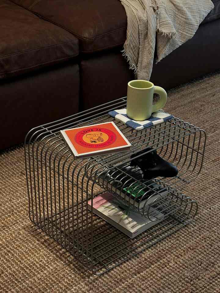 Brown loveseat and silver metal table in a brown-toned cozy living room space