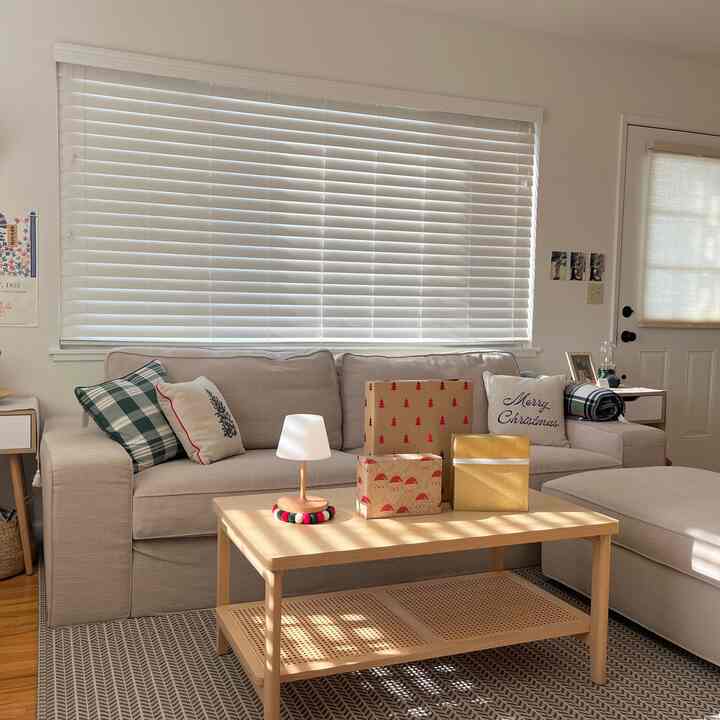 Beige and wood tone living room featuring comfortable sofa and coffee table in a cozy setting