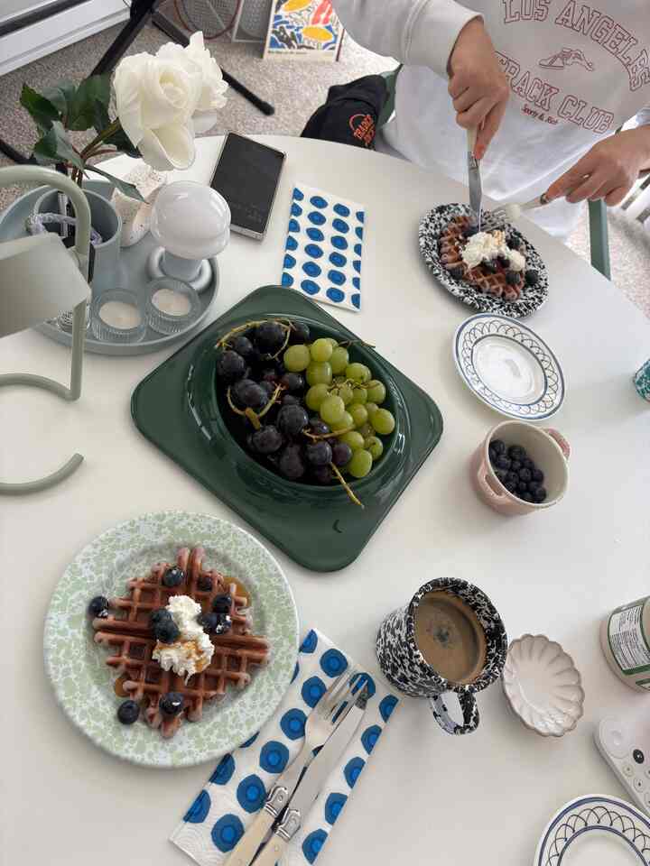 White and blue toned dining table featuring fresh fruits and waffles for a two-person home cafe brunch setup