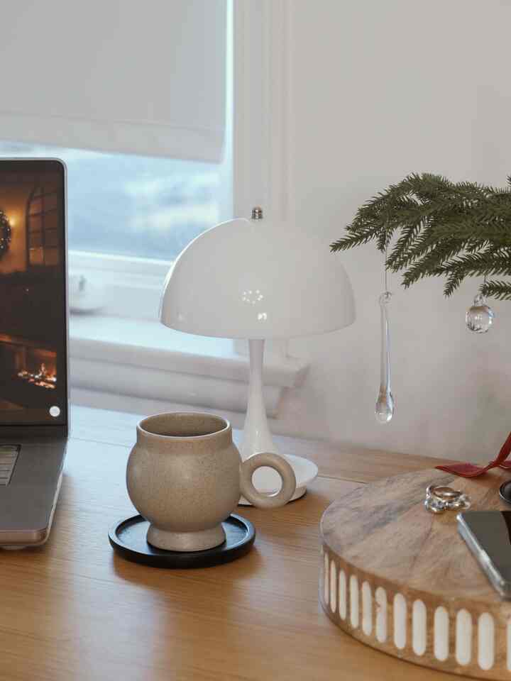 Gently hanging a clear ornament on this little centerpiece today.

It’s plastic but has that glass-like shine, and it’s so lightweight it sits perfectly even on the most delicate branches. Isn’t it so pretty?

And of course, nothing completes the holiday vibe like a cozy mug and a warm little light by my side while I work.

#WelcomeChallenge #moodlighting #cozycorners #glowseason #homeinspiration #officeroom #officedesk #familyroom #mug #holidayvibe #holidays #modern #homedecor #ornaments #centerpiece