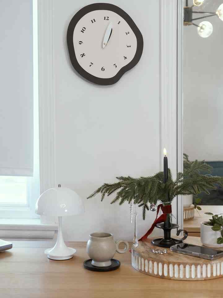 A front shot of the clock and my mug — and wow, how pretty are they together?

The whole desk suddenly feels so much more vibrant.

I love that the clock has such a playful shape, but the black color makes it blend perfectly with my office room.


#WelcomeChallenge #moodlighting #cozycorners #glowseason #homeinspiration #officeroom #officedesk #familyroom #mug #holidayvibe #holidays #modern #homedecor #ornaments #centerpiece