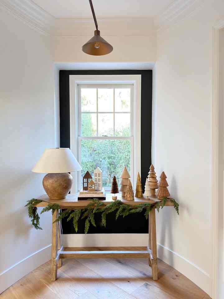 Festive trees and garland in our entryway. #woodtrees #christmasdecor #christmasdecorating