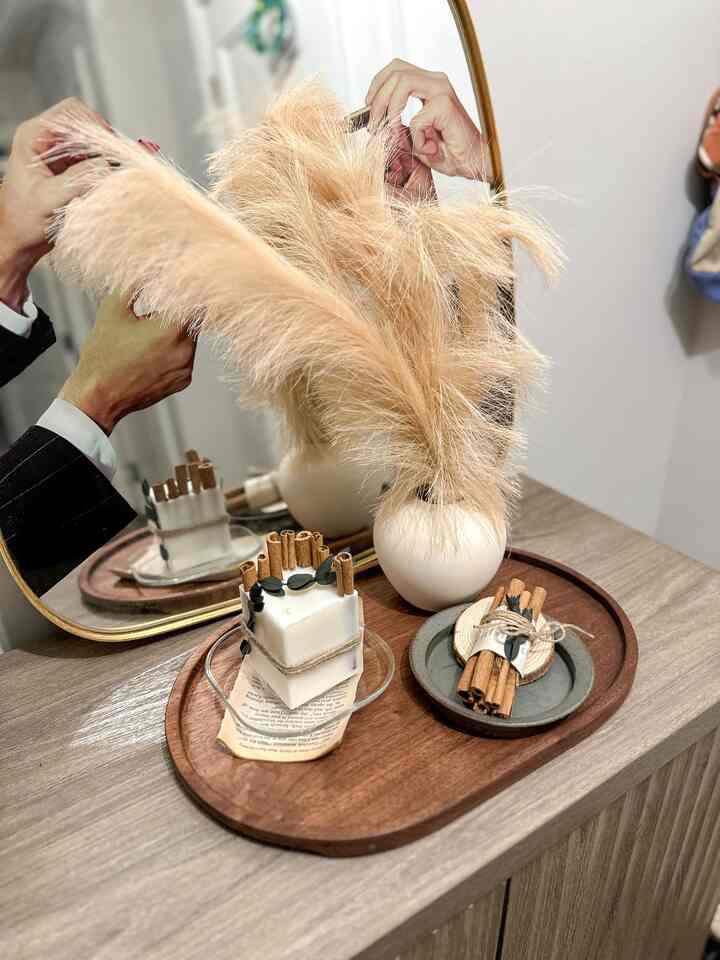 Natural color and wood tone entrance space featuring a candle and brown wooden tray creating a warm atmosphere