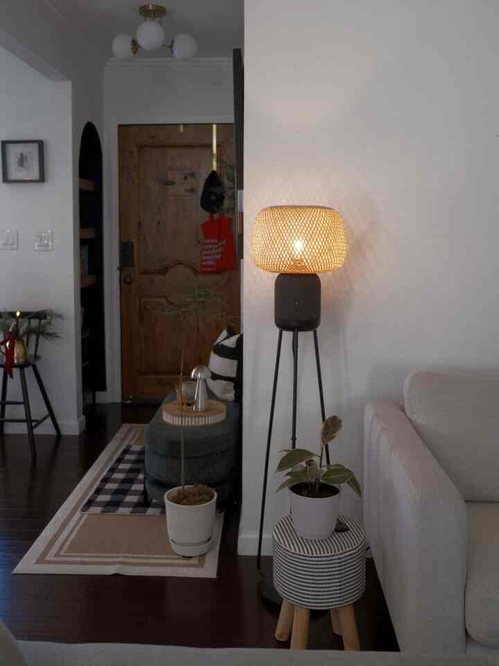 Nordic modern entrance and living room decorated space featuring warm lighting and a striking red eco-bag