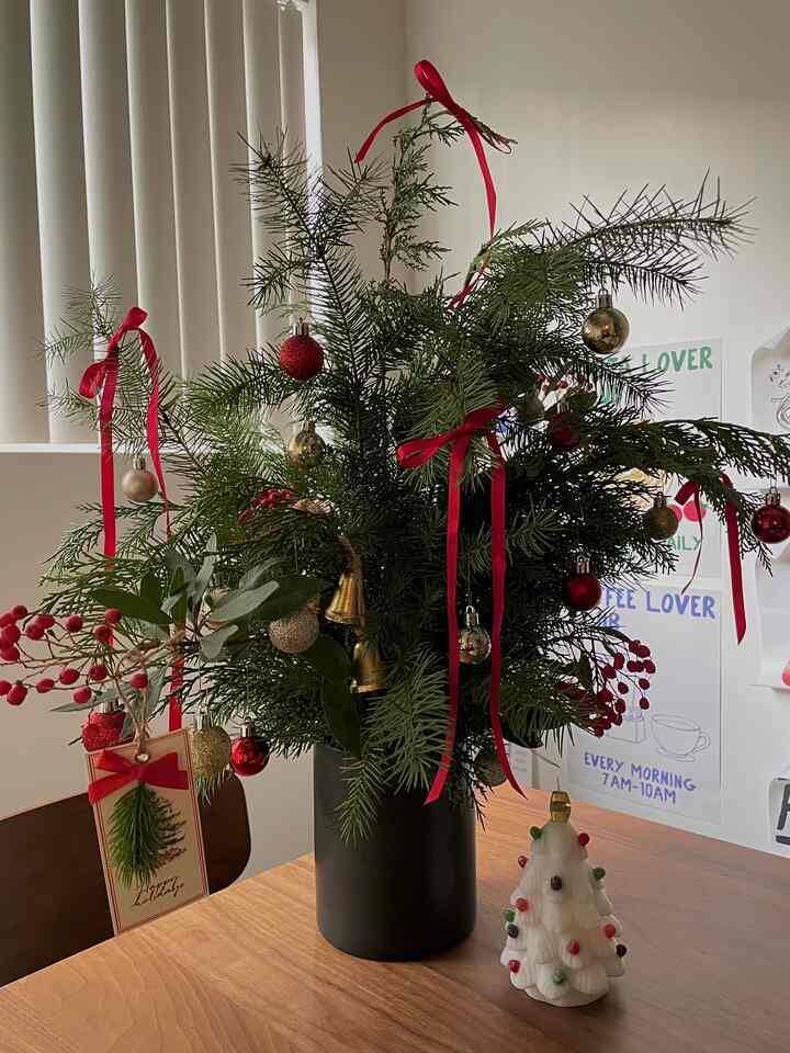 Natural modern dining room with wood-tone table featuring Christmas decor on top