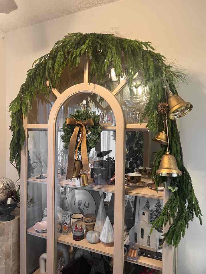 Keeping holiday decor simple and letting the cabinet shine.
Greenery and warm details make the space feel cozy and festive.

#OhouseTree #OhouseGather #OhouseGlow #CozyHome #holidaydecor #christmashome #livingroomstyling #moderncozy