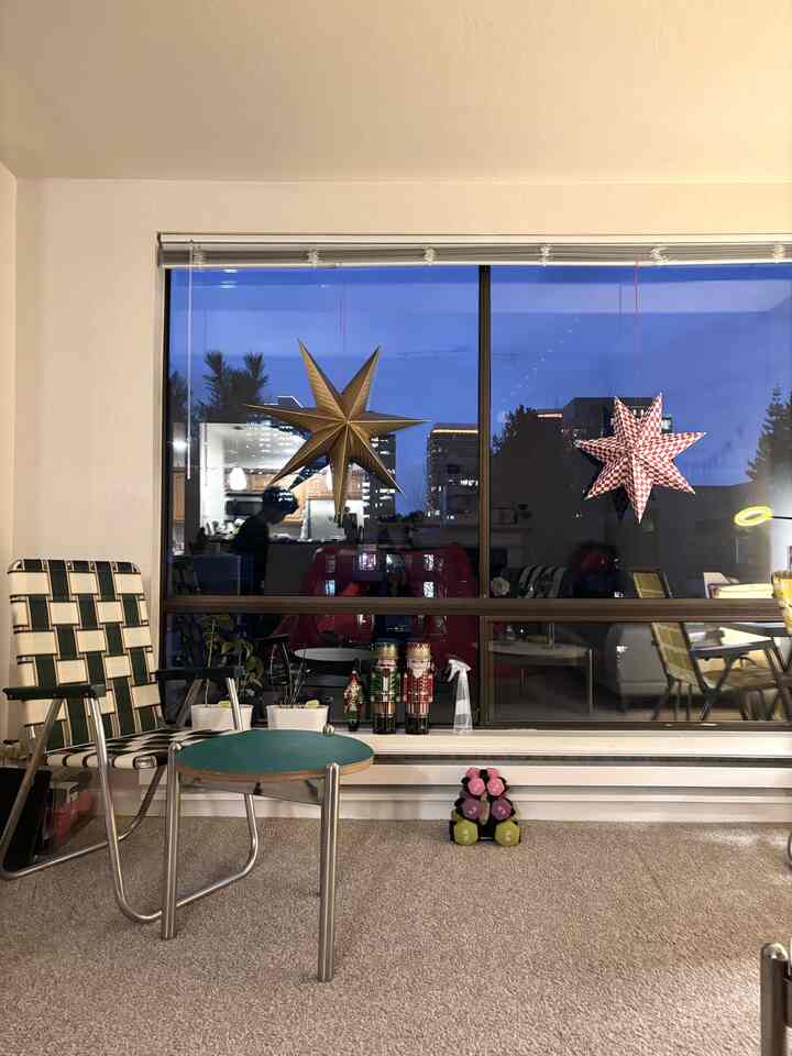 Gold and red toned window area featuring armchairs and a small side table in a cozy interior