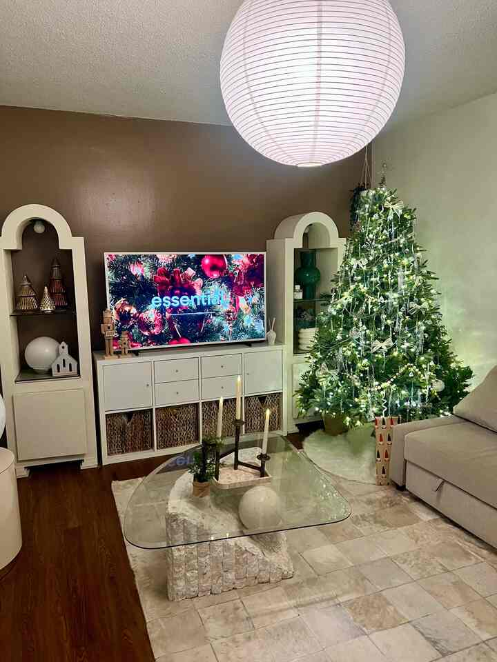 A Christmas living room that feels calm and lived in.
Soft lighting, simple furniture, and just enough holiday details to make the space feel warm and welcoming.

#OhouseTree #OhouseGlow #CozyHome  
#OhouseGather #holidayhome #tabledecor 
#OhouseGrateful #livingroomdecor #christmashome #holidayliving #cozyinteriors #homestyling #winterhome