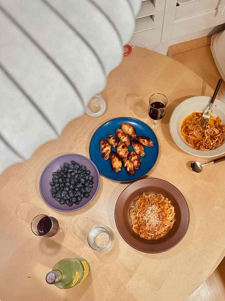 Warm wood tone dining room featuring various plates and glasses arranged for a cozy meal