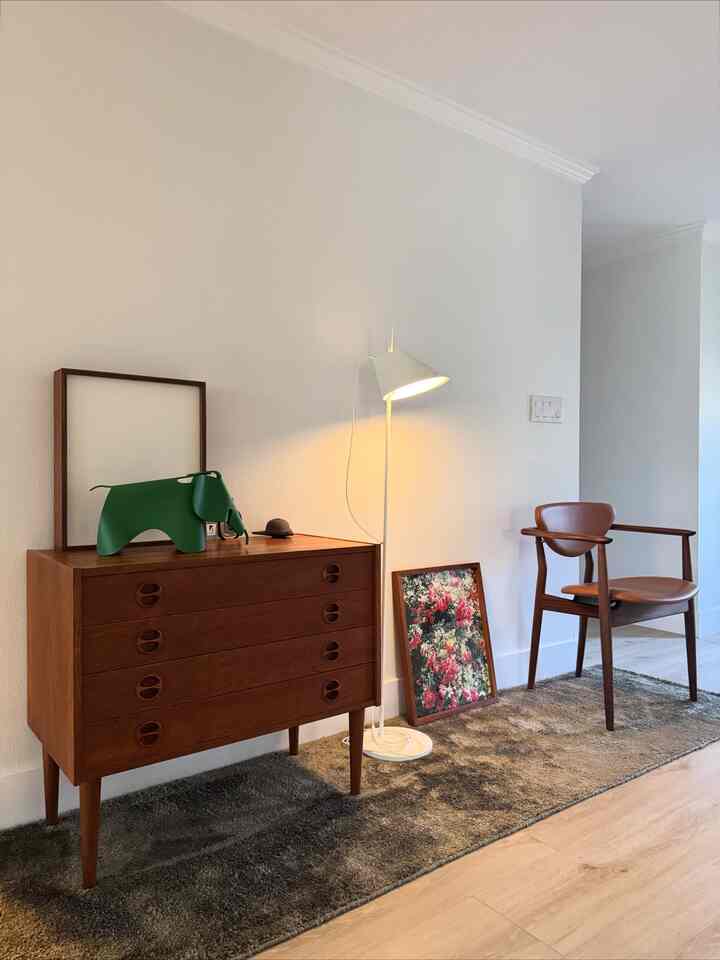 Brown-toned entrance space featuring mid-century modern furniture and floor lamp with a cozy atmosphere