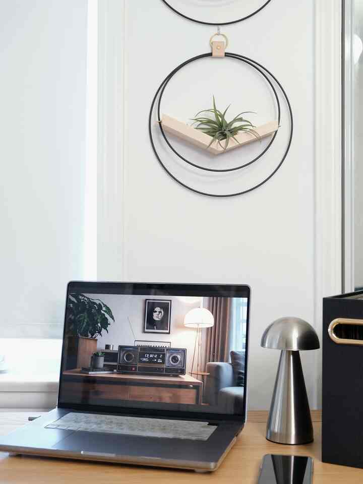 Silver-toned home office space featuring a laptop and chrome silver table lamp on a clean desk setup