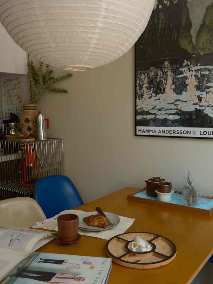 Brown and blue toned dining room featuring a wooden dining table and pendant light, creating a natural and cozy home cafe atmosphere