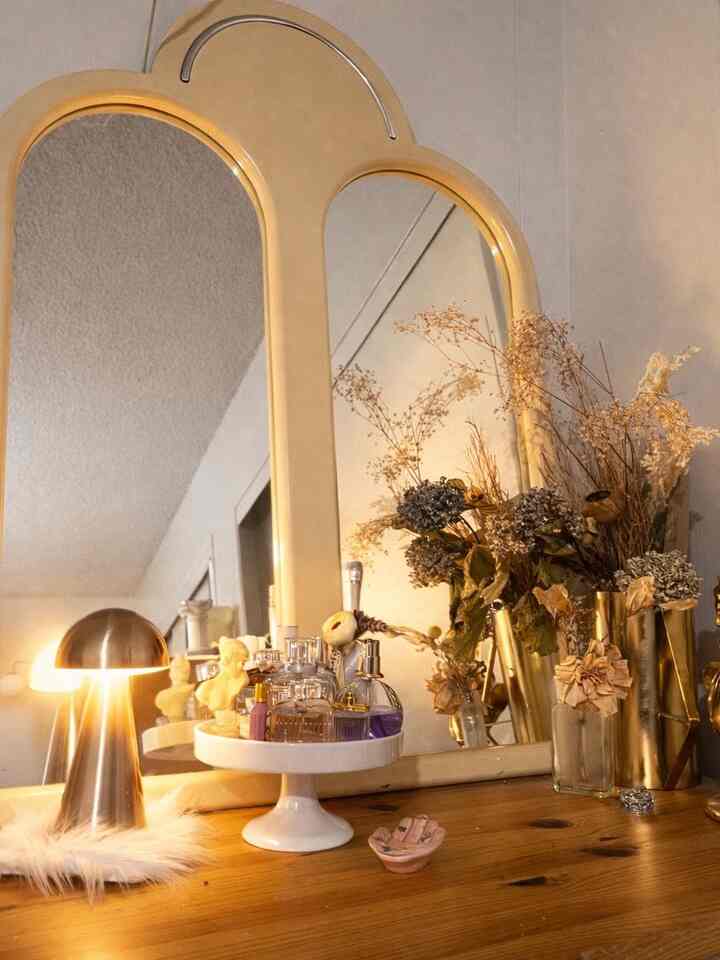 Warm gold and wood-toned bedroom nightstand featuring soft lighting and decorative vases creating a cozy atmosphere