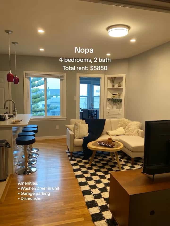 Modern open plan living room and kitchen for a 4-person household with white and wood tones, featuring a sectional sofa and round coffee table