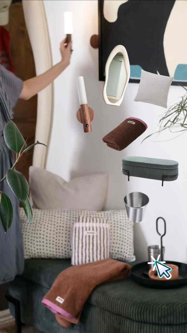 Charcoal and green toned dining corner with sofa and entrance features, including wall sconce, uniquely shaped mirror, towels and cushions creating cozy atmosphere