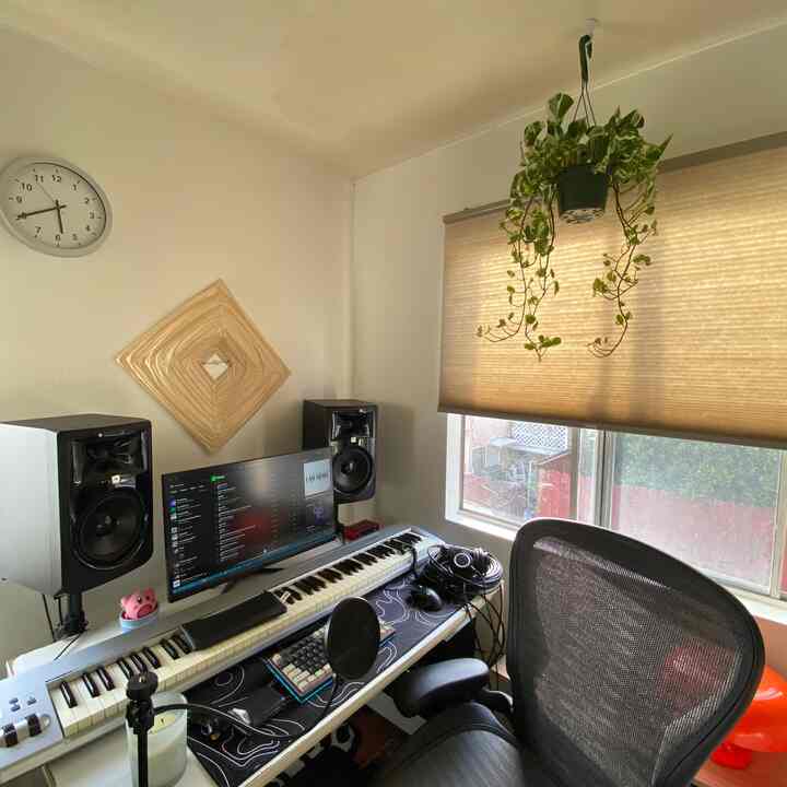 Beige-toned blinds and natural plant in a compact home office space designed for remote work